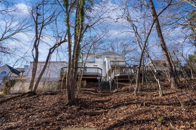 back of property with a wooden deck