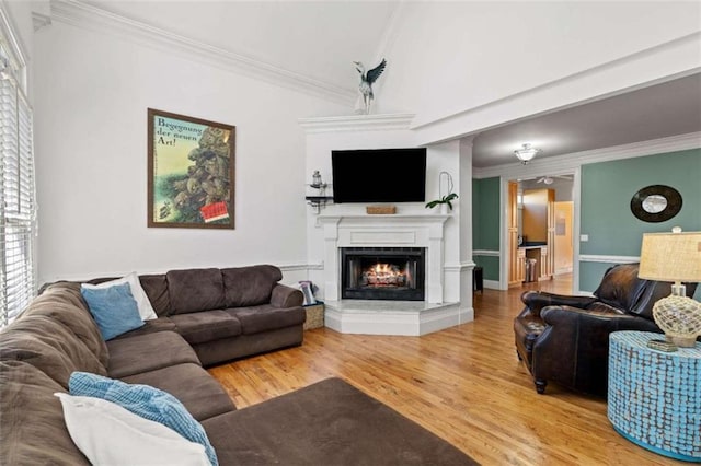 living room featuring wood-type flooring and crown molding