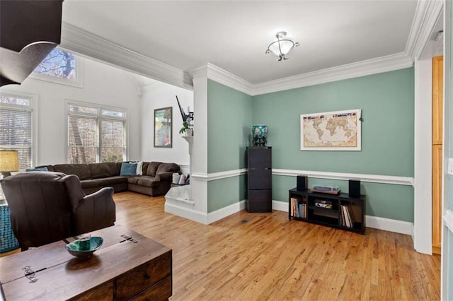 living room featuring light wood-type flooring and ornamental molding