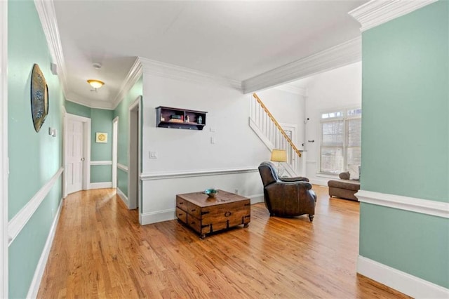 living area featuring hardwood / wood-style floors and ornamental molding