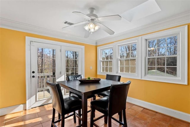 dining room featuring crown molding, light tile patterned flooring, and ceiling fan