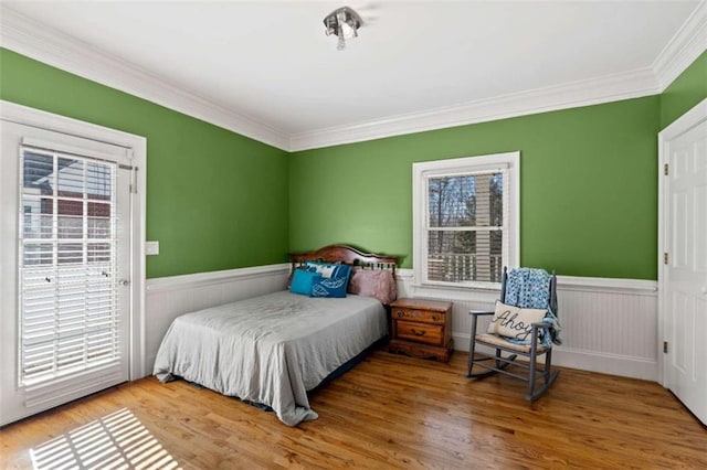 bedroom featuring hardwood / wood-style flooring and ornamental molding