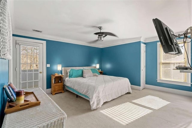 carpeted bedroom with ceiling fan and crown molding