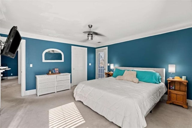 carpeted bedroom featuring ceiling fan and ornamental molding