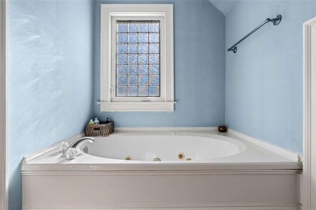 bathroom with a tub to relax in