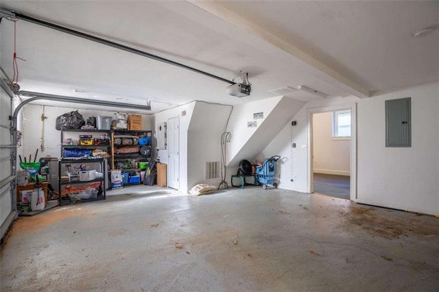 garage featuring electric panel and a garage door opener