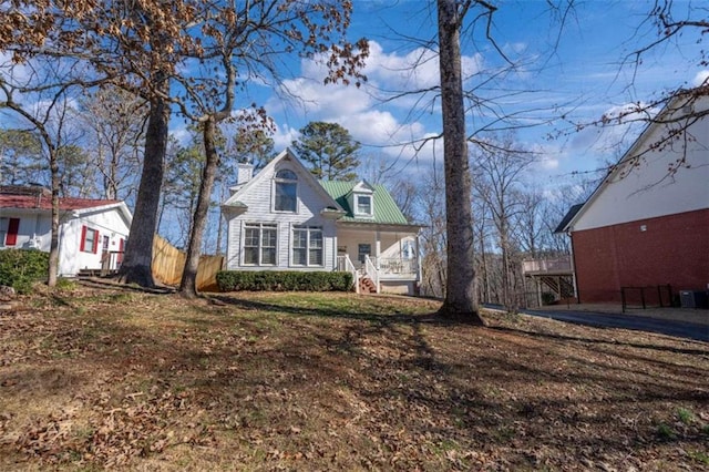 view of front facade with a porch and central AC