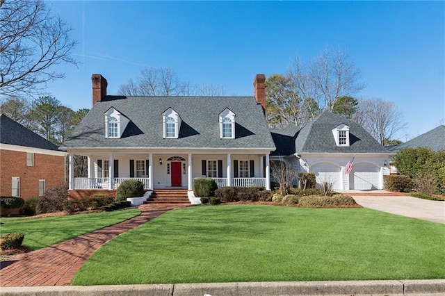 cape cod house with a garage, covered porch, and a front lawn