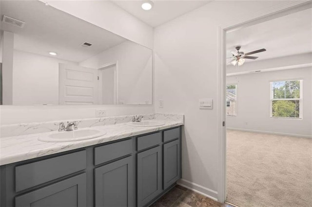 full bathroom featuring double vanity, visible vents, baseboards, and a sink