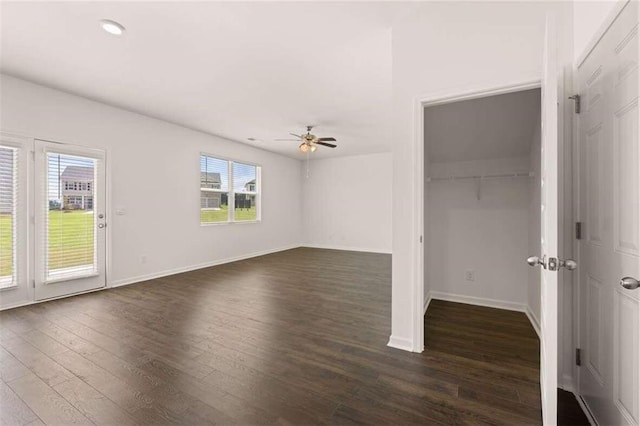 interior space with dark wood-style floors, baseboards, and ceiling fan