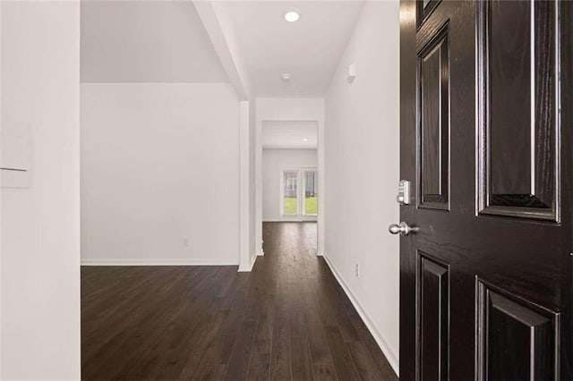 hall with recessed lighting, baseboards, and dark wood-style flooring