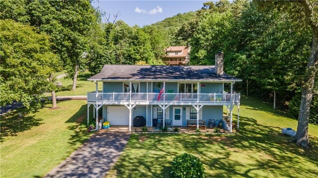 1008 Lakeview Acres, Hiawassee, GA 30546 - view of front of home featuring a garage, driveway, a front lawn, and a chimney