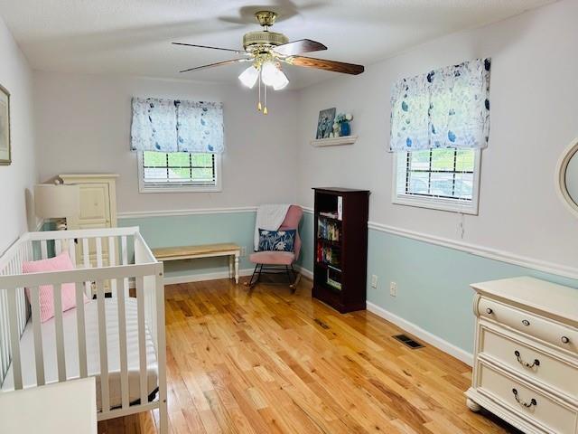 1008 Lakeview Acres, Hiawassee, GA 30546 - bedroom with light wood-style floors, a ceiling fan, and baseboards