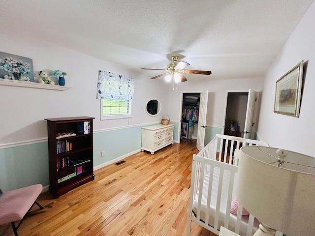1008 Lakeview Acres, Hiawassee, GA 30546 - bedroom featuring light wood-type flooring, a closet, ceiling fan, and baseboards