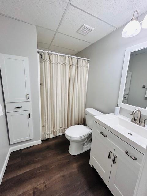 1008 Lakeview Acres, Hiawassee, GA 30546 - bathroom with wood finished floors, toilet, vanity, curtained shower, and a drop ceiling