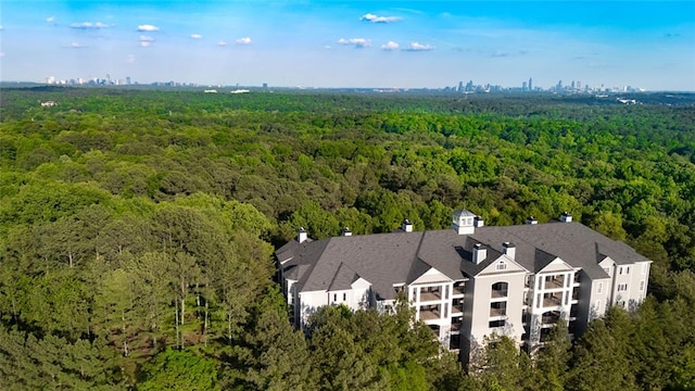 bird's eye view with a wooded view