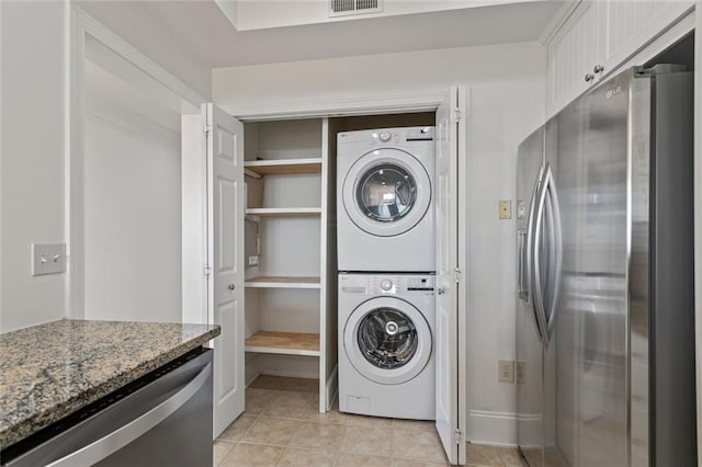 4100 Paces Walk SE Unit 4306, Atlanta, GA 30339 - washroom with estacked washer and dryer and light tile patterned floors