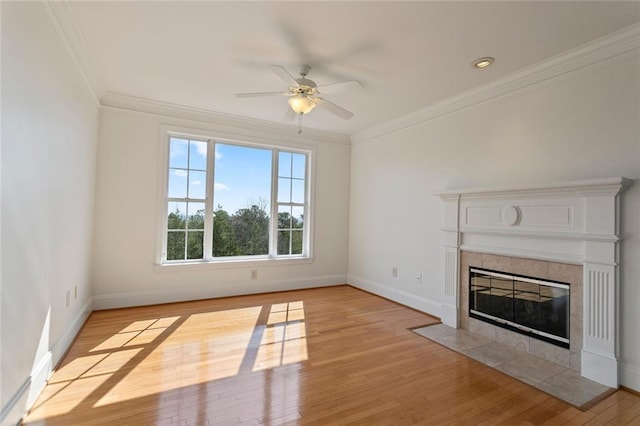 4100 Paces Walk SE Unit 4306, Atlanta, GA 30339 - unfurnished living room featuring ceiling fan, light wood-style floors, ornamental molding, baseboards, and a tiled fireplace