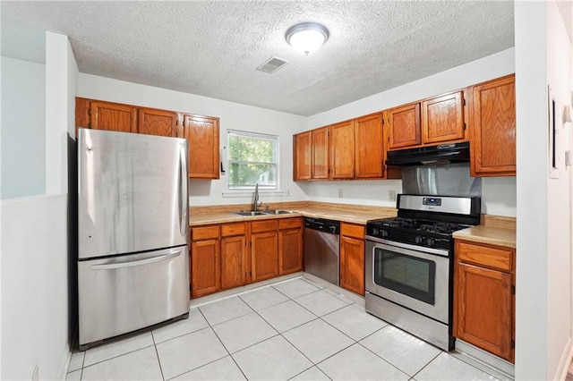 3799 Henry Ct, Acworth, GA 30101 - kitchen with stainless steel appliances, under cabinet range hood, a sink, light countertops, and brown cabinets