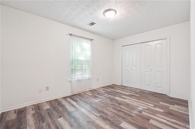3799 Henry Ct, Acworth, GA 30101 - unfurnished bedroom with wood finished floors, a textured ceiling, baseboards, and a closet