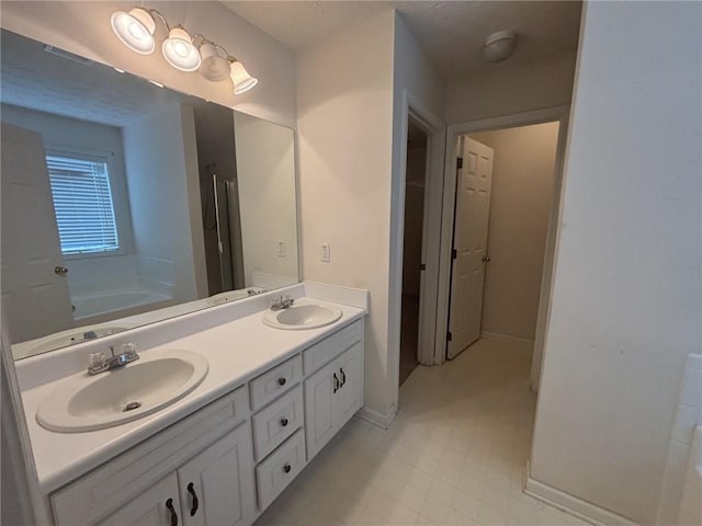 2840 Alcovy River Vw, Dacula, GA 30019 - full bath with double vanity, a garden tub, and baseboards