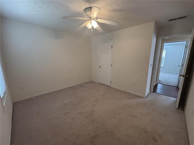 2840 Alcovy River Vw, Dacula, GA 30019 - spare room featuring light carpet, baseboards, a textured ceiling, and a ceiling fan