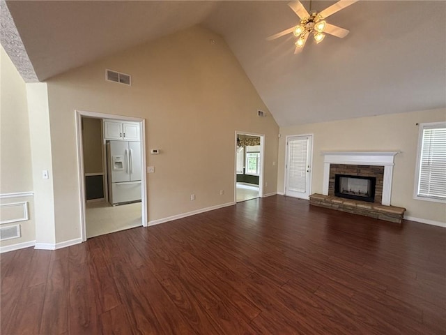 2840 Alcovy River Vw, Dacula, GA 30019 - unfurnished living room featuring high vaulted ceiling, a ceiling fan, dark wood-style floors, a stone fireplace, and baseboards