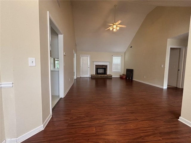 2840 Alcovy River Vw, Dacula, GA 30019 - unfurnished living room with ceiling fan, dark wood-style floors, high vaulted ceiling, a brick fireplace, and baseboards