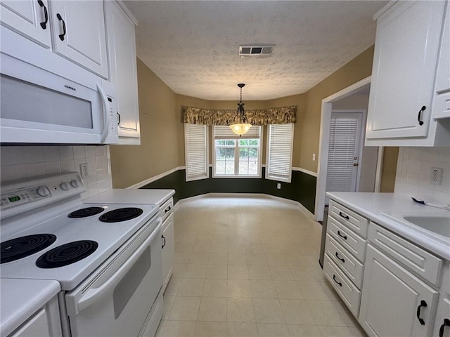 2840 Alcovy River Vw, Dacula, GA 30019 - kitchen featuring white appliances, a textured ceiling, white cabinets, backsplash, and light countertops