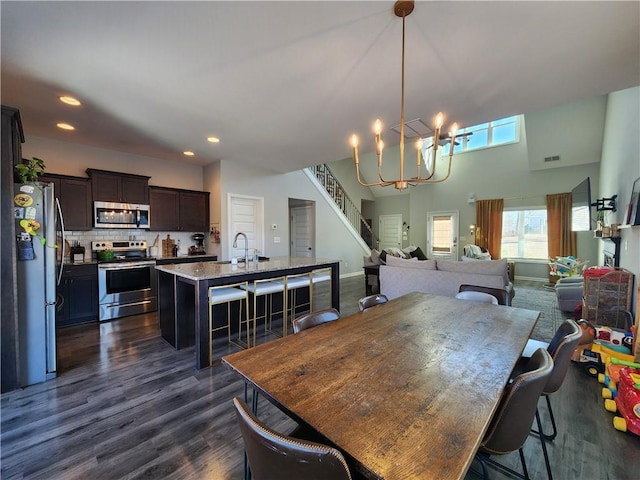 dining area with visible vents, dark wood-style floors, stairs, a chandelier, and recessed lighting