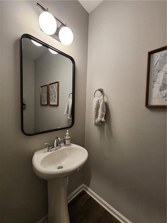 bathroom featuring baseboards and wood finished floors