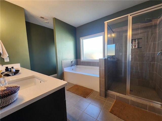 bathroom with visible vents, a sink, a shower stall, a bath, and tile patterned floors