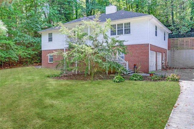 view of front of property featuring a garage and a front yard