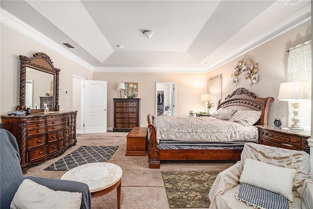 carpeted bedroom featuring visible vents, a walk in closet, a tray ceiling, and ornamental molding