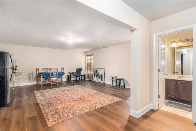 sitting room featuring baseboards and wood finished floors