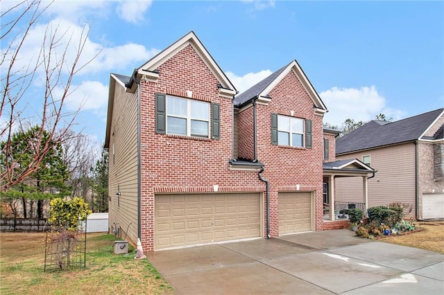 traditional home with brick siding, a front lawn, fence, concrete driveway, and a garage