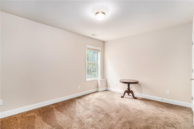 empty room with visible vents, baseboards, and carpet