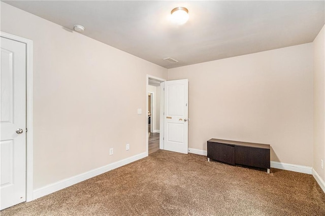 unfurnished bedroom with baseboards and carpet