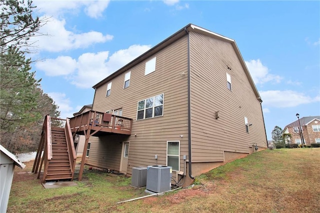 rear view of property featuring a deck, stairway, central air condition unit, and a yard