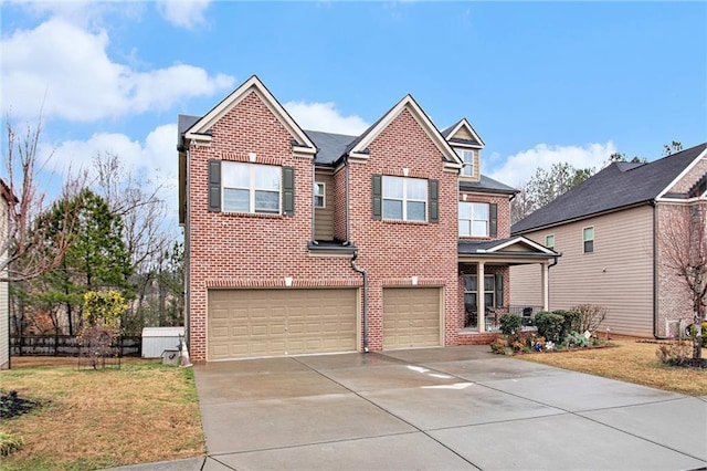 traditional-style home featuring brick siding, driveway, and a garage