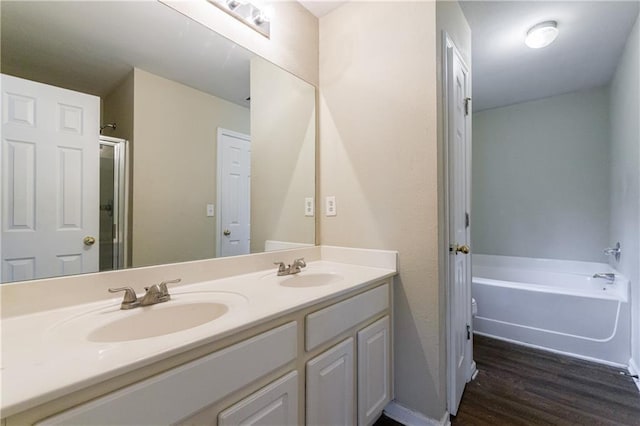 10247 Deep Creek Pl, Union City, GA 30291 - full bath featuring double vanity, wood finished floors, and a garden tub