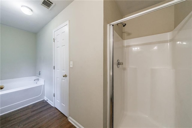 10247 Deep Creek Pl, Union City, GA 30291 - full bathroom with wood finished floors, a stall shower, a garden tub, and baseboards