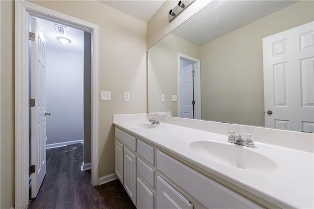10247 Deep Creek Pl, Union City, GA 30291 - bathroom with double vanity, wood finished floors, and baseboards