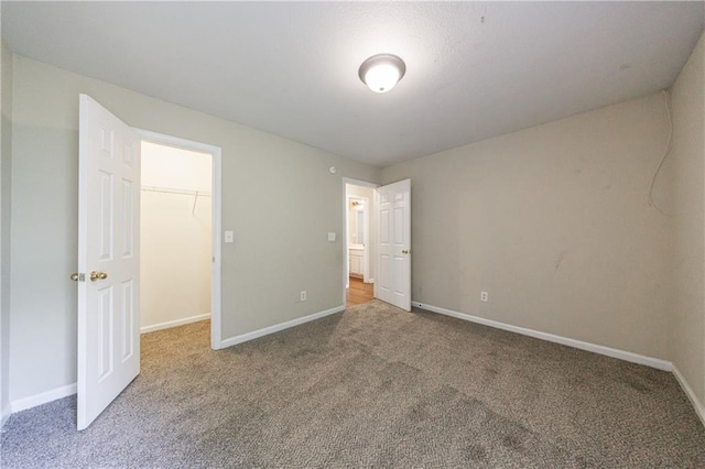10247 Deep Creek Pl, Union City, GA 30291 - unfurnished bedroom featuring carpet floors, a walk in closet, baseboards, and a closet