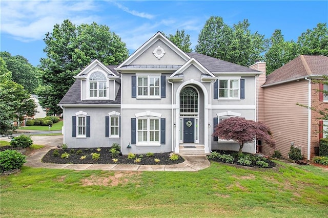 200 Ridge Bluff Ln, Suwanee, GA 30024 - view of front facade featuring stucco siding, a front yard, and a shingled roof