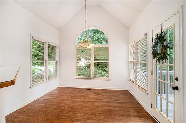 200 Ridge Bluff Ln, Suwanee, GA 30024 - empty room featuring a chandelier, healthy amount of natural light, vaulted ceiling, and dark wood finished floors