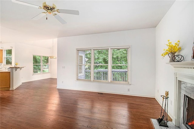 200 Ridge Bluff Ln, Suwanee, GA 30024 - unfurnished living room with a high end fireplace, wood finished floors, a ceiling fan, and baseboards