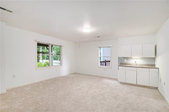 200 Ridge Bluff Ln, Suwanee, GA 30024 - unfurnished living room with a sink, light carpet, and baseboards