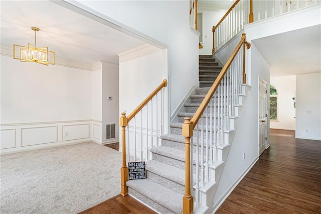 200 Ridge Bluff Ln, Suwanee, GA 30024 - stairs featuring wood finished floors, a chandelier, and ornamental molding