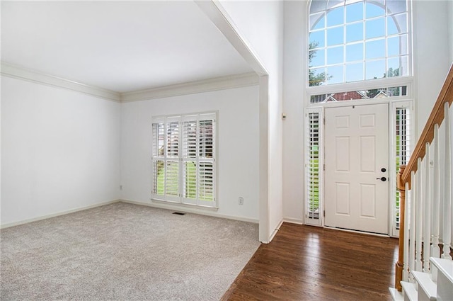 200 Ridge Bluff Ln, Suwanee, GA 30024 - entrance foyer featuring stairs, baseboards, ornamental molding, carpet floors, and wood finished floors